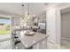 Bright eat-in kitchen features stainless steel appliances, pendant lighting, and a large center island at 5651 Nw 40Th Pl, Ocala, FL 34482