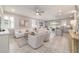 Open-concept living room featuring neutral decor, tiled floors, and seamlessly connected kitchen at 5651 Nw 40Th Pl, Ocala, FL 34482