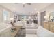 Bright and open living room flowing into a modern kitchen with an island and stainless steel appliances at 5651 Nw 40Th Pl, Ocala, FL 34482