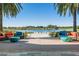 Scenic outdoor seating area overlooking a lake, framed by palm trees and comfortable chairs at 5651 Nw 40Th Pl, Ocala, FL 34482