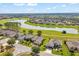 Panoramic aerial view of homes surrounding a tranquil lake and golf course in a planned community at 6683 Sw 97Th Terrace Rd, Ocala, FL 34481
