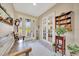 Welcoming entryway featuring tile flooring, a bench, and a decorative display cabinet at 6683 Sw 97Th Terrace Rd, Ocala, FL 34481
