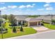 Well-manicured single-story home featuring a three-car garage, lush landscaping, and a pristine front lawn at 6683 Sw 97Th Terrace Rd, Ocala, FL 34481
