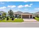 Charming single-story home with a three-car garage and manicured front yard featuring lush landscaping at 6683 Sw 97Th Terrace Rd, Ocala, FL 34481