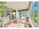 Bright Florida room with a dining table, large windows, and views of the backyard at 6683 Sw 97Th Terrace Rd, Ocala, FL 34481