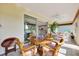 Sunny Florida room with views of the kitchen, backyard, and comfortable seating at 6683 Sw 97Th Terrace Rd, Ocala, FL 34481