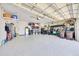 Spacious three-car garage with epoxy floors and ample storage space at 6683 Sw 97Th Terrace Rd, Ocala, FL 34481
