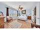 This spacious main bedroom features hardwood floors, a ceiling fan and an ensuite bathroom at 6683 Sw 97Th Terrace Rd, Ocala, FL 34481