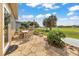 Stone patio with an outdoor dining set and serene views of the landscaped golf course at 6683 Sw 97Th Terrace Rd, Ocala, FL 34481