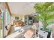 Bright sunroom with tile floors, ceiling fan, sliding doors, and comfortable seating with natural light at 6683 Sw 97Th Terrace Rd, Ocala, FL 34481