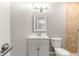 Bright bathroom featuring a single sink vanity, a mirror, and a tiled standing shower at 6989 Se 52Nd Pl, Ocala, FL 34472