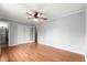 A bedroom featuring wood laminate flooring, neutral colored walls, ceiling fan, and a double door closet at 6989 Se 52Nd Pl, Ocala, FL 34472