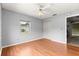 Bedroom featuring wood floors, a large closet, and a window offering natural light at 6989 Se 52Nd Pl, Ocala, FL 34472