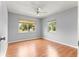 Bedroom with wood floors, ample natural light from two windows, and neutral paint at 6989 Se 52Nd Pl, Ocala, FL 34472