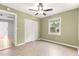 Well-lit bedroom with wood-look flooring, closet, and a bright window at 6989 Se 52Nd Pl, Ocala, FL 34472