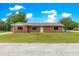A single-story brick home with a well-manicured front yard and inviting curb appeal at 6989 Se 52Nd Pl, Ocala, FL 34472