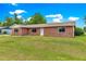 Charming single-story brick home with a well-maintained lawn and inviting entrance at 6989 Se 52Nd Pl, Ocala, FL 34472