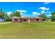 Charming brick home featuring a well-manicured lawn and desirable curb appeal at 6989 Se 52Nd Pl, Ocala, FL 34472