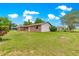 Well maintained, green lawn and beautiful landscaping surround this brick home at 6989 Se 52Nd Pl, Ocala, FL 34472