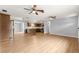 Open living room with wood floors offers an easy flow to the kitchen and breakfast bar at 6989 Se 52Nd Pl, Ocala, FL 34472