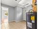 A utility room featuring a water heater, tiled flooring, neutral paint, and access to the backyard at 6989 Se 52Nd Pl, Ocala, FL 34472