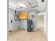 A utility room featuring a water heater, tiled flooring, a washer hook up, neutral paint, and backyard access at 6989 Se 52Nd Pl, Ocala, FL 34472