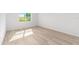 Bright bedroom features a large window and wood-look flooring at 7203 Sw 86Th Ave, Ocala, FL 34481