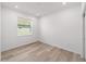Bright bedroom with hardwood floors and a large window overlooking the backyard at 7203 Sw 86Th Ave, Ocala, FL 34481