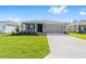 Attractive home with a well-kept lawn and spacious driveway leading to the garage at 7203 Sw 86Th Ave, Ocala, FL 34481