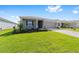 Well-maintained home featuring a lush green lawn and concrete driveway at 7203 Sw 86Th Ave, Ocala, FL 34481