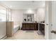 Bright bathroom with dual sink vanity, granite countertops, soaking tub, and glass shower at 8142 Sw 59Th Ave, Ocala, FL 34476