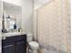 Full bathroom with combined shower and tub, stylish shower curtain, vanity, mirror, and toilet at 8142 Sw 59Th Ave, Ocala, FL 34476