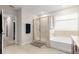 Neutral bathroom featuring tub, glass shower enclosure, and towel bar at 8142 Sw 59Th Ave, Ocala, FL 34476
