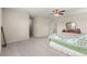 Large bedroom features neutral carpet, ceiling fan, dresser, and leads to bathroom and closet at 8142 Sw 59Th Ave, Ocala, FL 34476
