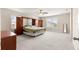 Spacious bedroom featuring neutral carpet, fan, and built-in cabinets with dressers on either side of bed at 8142 Sw 59Th Ave, Ocala, FL 34476