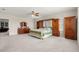 Spacious bedroom featuring neutral carpet, fan, and built-in cabinets with dressers on either side of bed at 8142 Sw 59Th Ave, Ocala, FL 34476