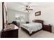 Cozy bedroom featuring a ceiling fan, desk, carpet, and a window for natural light at 8142 Sw 59Th Ave, Ocala, FL 34476
