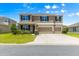Traditional two-story home with a three-car garage and well-manicured lawn at 8142 Sw 59Th Ave, Ocala, FL 34476