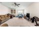 Spacious living room featuring comfortable seating, a ceiling fan, and a large window offering natural light at 8142 Sw 59Th Ave, Ocala, FL 34476