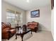 Cozy living room with tile flooring, a large window, and leather furniture at 8142 Sw 59Th Ave, Ocala, FL 34476