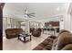 Spacious living room with neutral tile flooring flows into open kitchen with bar seating at 8142 Sw 59Th Ave, Ocala, FL 34476