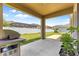 Covered patio featuring a grill and view of the fenced backyard, perfect for outdoor cooking and relaxation at 8142 Sw 59Th Ave, Ocala, FL 34476