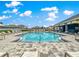 Community pool surrounded by lounge chairs and a shaded area for relaxing at 8142 Sw 59Th Ave, Ocala, FL 34476