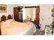 Bedroom featuring a decorative bed frame, ample storage, and natural light from the window at 8321 Sw 108Th Place Rd, Ocala, FL 34481