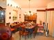 Spacious dining room with a chandelier and ample natural light from a nearby window at 8321 Sw 108Th Place Rd, Ocala, FL 34481