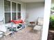 This front porch is set up with plenty of spots to relax at 8321 Sw 108Th Place Rd, Ocala, FL 34481