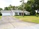 A single story home is shown with an attached garage and long driveway at 8321 Sw 108Th Place Rd, Ocala, FL 34481