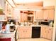 Well-lit kitchen with ample counter space, modern appliances, and pass-through to dining area at 8321 Sw 108Th Place Rd, Ocala, FL 34481