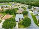 An aerial view of the home showcasing lush landscaping and mature trees at 8961 Se 130Th Loop, Summerfield, FL 34491