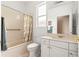 Bathroom with a tub, a toilet, a vanity, and a large mirror at 8961 Se 130Th Loop, Summerfield, FL 34491